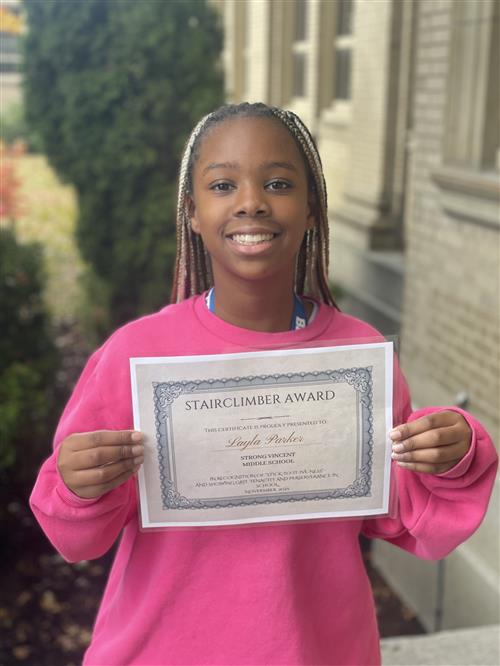 Layla Parker, Strong Vincent's Stairclimber for October, poses with his award plaque.
